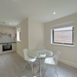 Modern kitchen with dining area and round table.