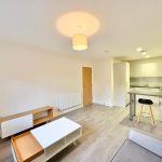 Modern open-plan living room and kitchen interior.