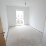 Empty room with beige floor and window.