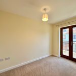 Empty room with carpet and French doors