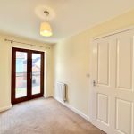 Empty room with French doors and light fixture