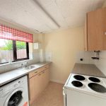 Small kitchen with cooker and washing machine