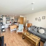 Modern open-plan living room and kitchen.