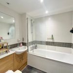 Modern bathroom with bathtub and sink.