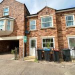 Modern brick house with multiple windows for rent.