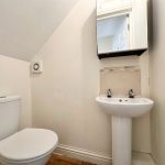 Small bathroom with toilet and sink.