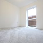 Empty room with carpet and window