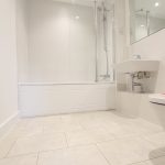 Modern bathroom with bathtub, sink, and toilet.