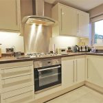 Modern kitchen with appliances and wooden cabinets.