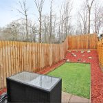 Back garden with wooden fences and patio furniture