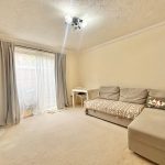 Bright living room with sofa and TV