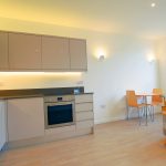 Modern flat interior with kitchen and dining area.