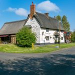 Quaint countryside pub with thatched roof