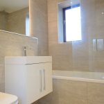 Modern bathroom with sink and bathtub.