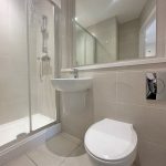 Modern bathroom with shower and toilet.