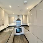 Modern kitchen with sleek cabinets and appliances.