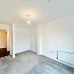 Empty room with grey carpet and radiator