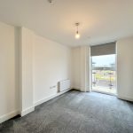 Empty room with carpet and large window