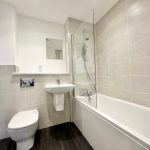 Modern bathroom with shower and bathtub.