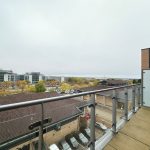 View from balcony over modern industrial buildings.