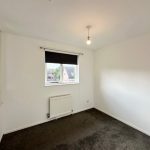 Empty room with window and carpet floor.