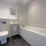 Modern bathroom with bathtub, toilet, and sink