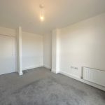 Empty room with carpet and radiator.