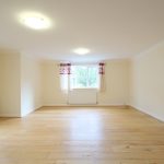 Spacious living room with wooden flooring.