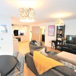 Modern open-plan living room and kitchen area.