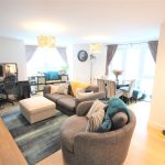Modern living room with sofas and dining area.