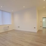 Modern empty living room with wooden flooring.