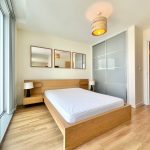 Minimalist bedroom with wooden furniture and modern lighting