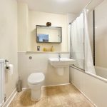 Modern bathroom with bathtub and white tiles
