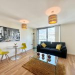 Modern living room with sofa and dining area.