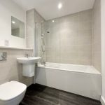 Modern white bathroom with shower and bath.