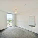 Empty room with carpet and large window