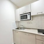 Modern compact kitchen with microwave and hob