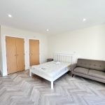 Modern bedroom with bed and sofa