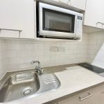Modern kitchen with microwave, sink, and hob.