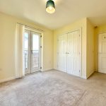 Bright empty room with doors and carpet