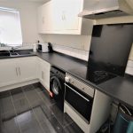 Modern kitchen with appliances and black countertops