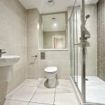 Modern bathroom with shower, sink, and toilet