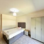 Spacious bedroom with bed and wardrobe