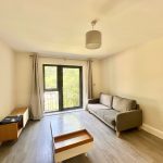 Minimalist living room with sofa and balcony view.