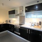 Modern black and white kitchen with appliances.