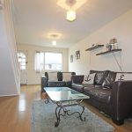 Cosy living room with brown leather sofas.