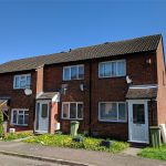 Two-storey brick terraced houses in residential area.