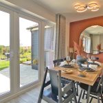 Dining room with garden view through French doors.