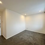 Small empty room with white walls and carpet.