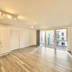 Spacious modern flat with balcony and wood flooring.